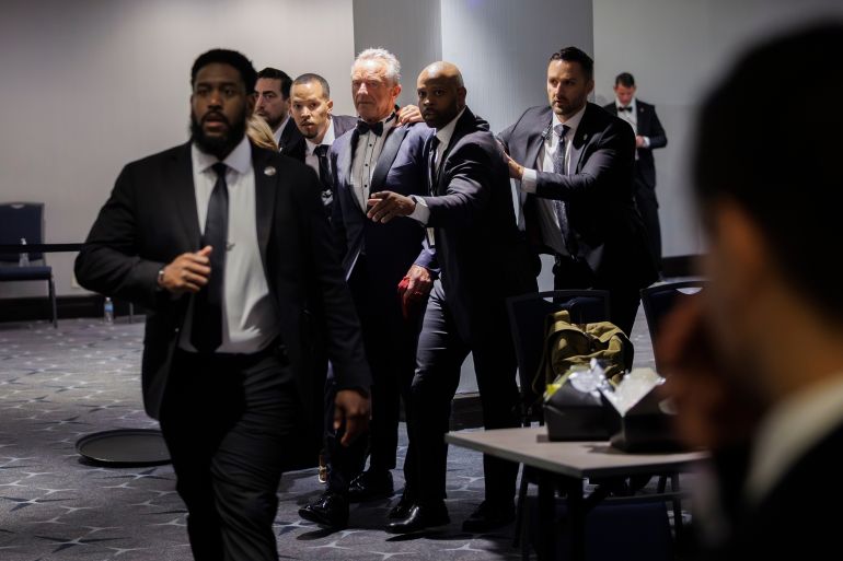 U.S. Health and Human Services Secretary Robert F. Kennedy Jr. and his wife, Cheryl Hines, are evacuated after an unspecified threat at the annual White House Correspondents' Association Dinner in Washington, Saturday, April 25, 2026. (AP Photo/Tom Brenner)