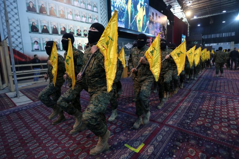epa12390318 Hezbollah members parade carrying the group's flags during a ceremony marking the first anniversary of the killing of senior Hezbollah commander Ibrahim Aqil, in the Dahieh suburb of Beirut, Lebanon, 19 September 2025. The Hezbollah top commander was killed on 20 September 2024 by an Israeli airstrike in the southern suburbs of Beirut. EPA/WAEL HAMZEH