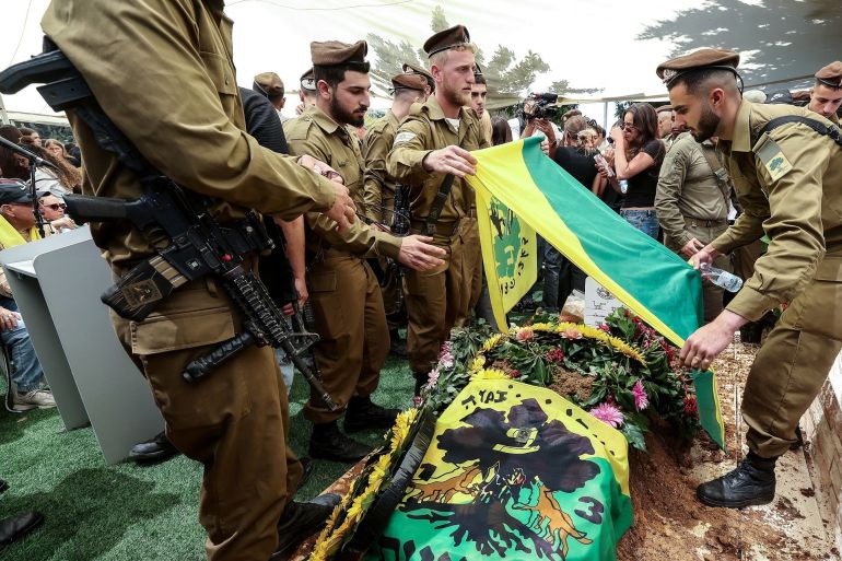 Comrades and family members mourn over the grave of 19-year-old Israeli army Sergeant Liem Ben Hamo, a combat soldier in the Golani Brigade's 13th Battalion, who was killed in combat in southern Lebanon by an explosive drone, during his funeral in Herzliya, on May 1, 2026. Another soldier was moderately wounded in the incident. Since the start of Operation Roaring Lion in late February, 16 Israeli soldiers have been killed in Lebanon. (Photo by Jack GUEZ / AFP via Getty Images) /