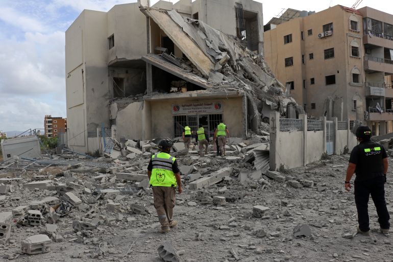 First responders inspect the destruction at the site of an Israeli airstrike that targeted the headquarters of a local NGO, in the southern coastal city of Tyre on May 15, 2026.