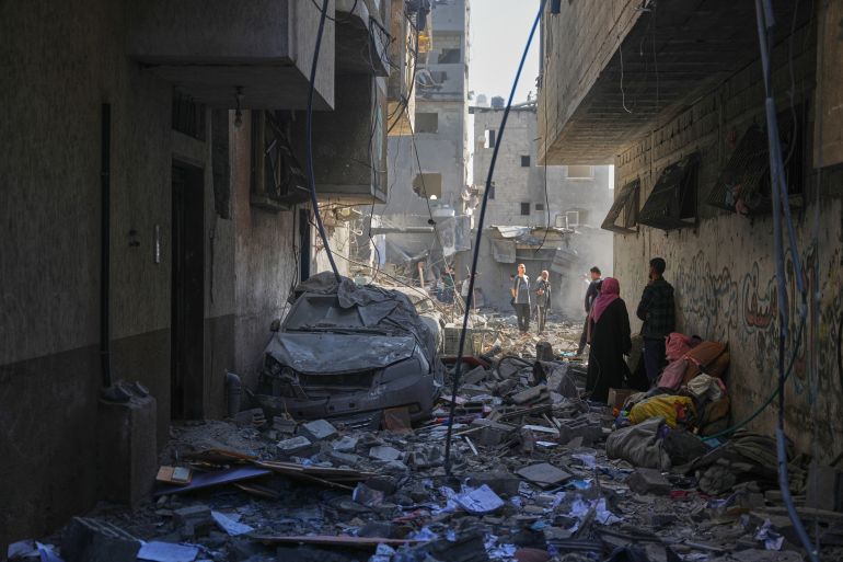 Residents inspect the rubble of a building that was destroyed by an Israeli airstrike in Nuseirat, central Gaza Strip, Saturday, May 23, 2026. (AP Photo/Abdel Kareem Hana)