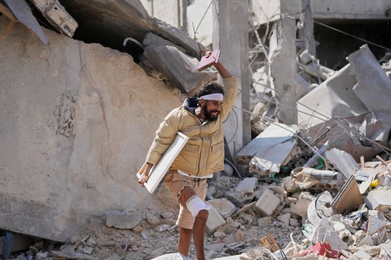 An injured resident carries belongings through the rubble of his home, a day after it was damaged in an Israeli airstrike in the southern village of Charnay, Lebanon, Wednesday, May 27, 2026. (AP Photo/Mohammed Zaatari)
