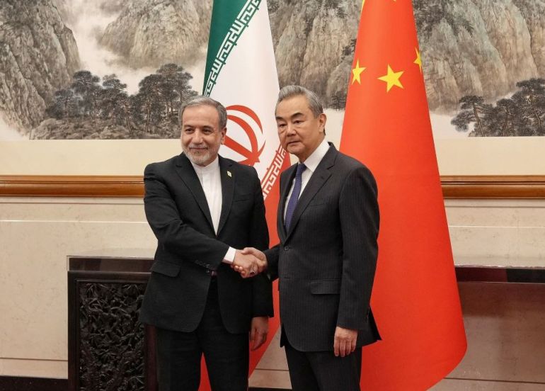 epa12935823 A handout picture made available by the Iranian foreign ministry office shows, China foreign minister Wang Yi (R) greets Iranian foreign minister Abbas Araghchi (L) in Beijing, China, 06 May 2026. EPA/IRANIAN FOREIGN MINISTRY OFFICE HANDOUT HANDOUT EDITORIAL USE ONLY/NO SALES