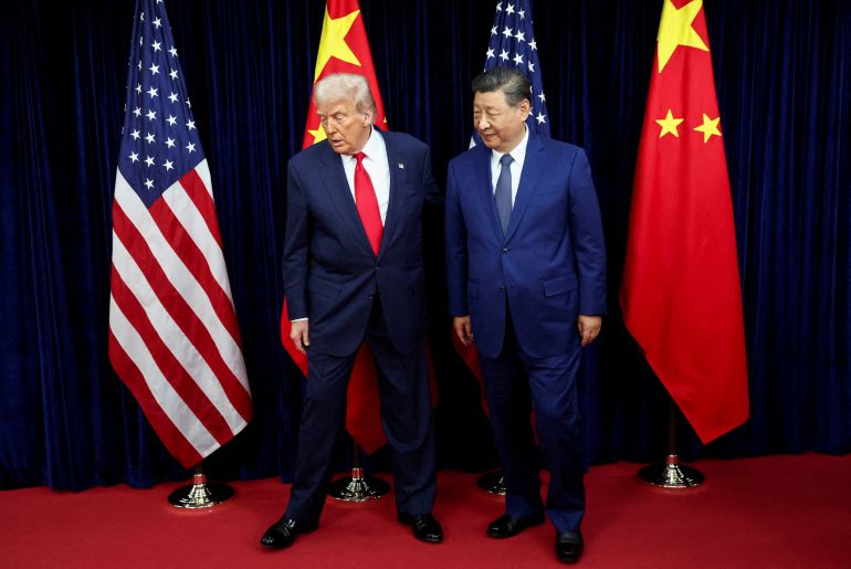 FILE PHOTO: U.S. President Donald Trump and Chinese President Xi Jinping walk, as they hold a bilateral meeting at Gimhae International Airport on the sidelines of the Asia-Pacific Economic Cooperation (APEC) summit in Busan, South Korea, on October 30, 2025. REUTERS/Evelyn Hockstein/File Photo
