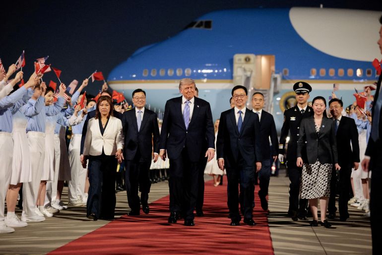 U.S. President Donald Trump walks with Chinese Vice President Han Zheng during an arrival ceremony at Beijing Capital International Airport, in Beijing, China, May 13, 2026. REUTERS/Evan Vucci TPX IMAGES OF THE DAY