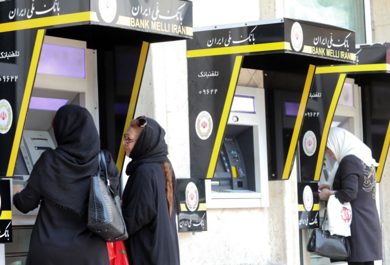 Iranian women use automated teller machines (ATM) in the capital Tehran on May 20, 2019. US President Donald Trump issued an ominous warning to Iran yesterday, suggesting that if the Islamic republic attacks American interests, it will be destroyed. (Photo by ATTA KENARE / AFP)