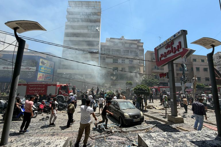People gather at the site of an Israeli airstrike that targeted a building in Beirut’s southern suburbs on June 14, 2026.