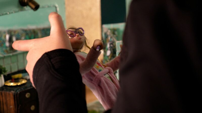 Tamara Finlay animating her childhood self alternatively-The artist adjusts a puppet of her childhood self. Photo courtesy of Gold House Media.