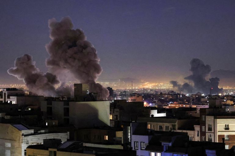 TOPSHOT - Smoke plumes rise following missile strikes in Tehran on March 1, 2026.