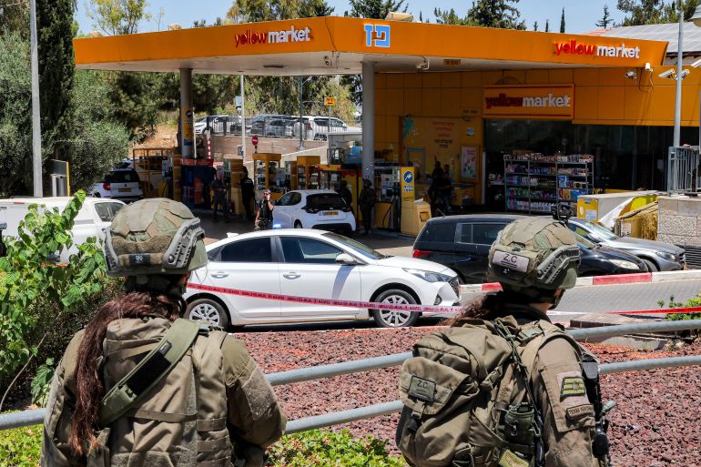 Israeli security forces gather at a petrol station following a suspected shooting attack near the town of Kokhav Yair in central Israel close to the occupied West Bank on June 7, 2026.