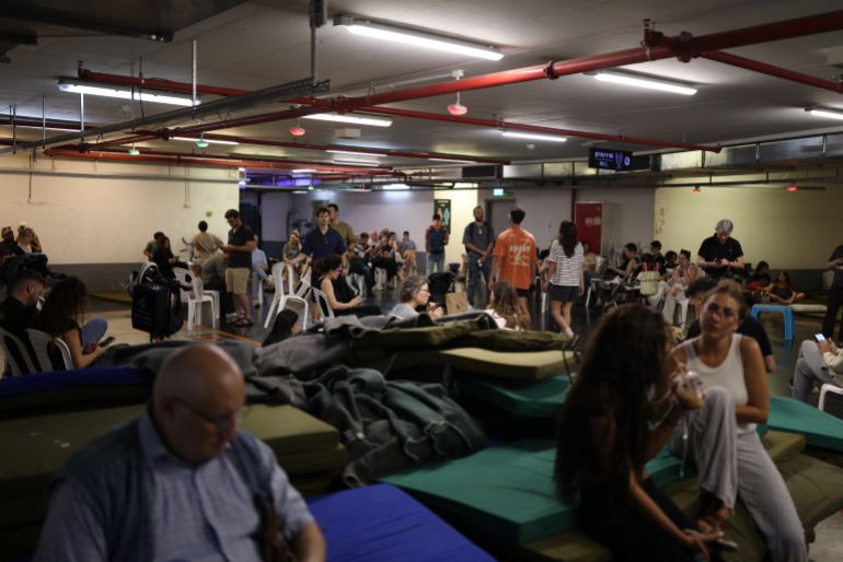 TOPSHOT - People take cover in a public shelter during a rocket attack alert in Tel Aviv on June 8, 2026.