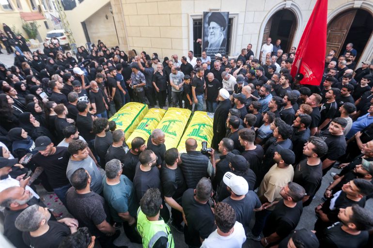 EDITORS NOTE: Graphic content / Mourners gather before the Hezbollah flag-draped bodies of four women who were killed the previous day following Israeli bombardment on the village of Qannarit, south of Sidon in southern Lebanon, during the funeral in the village on June 21, 2026.