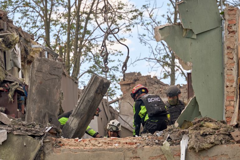 epa13051146 Ukrainian rescuers work at the site of a Russian glide bomb strike on a residential building in Kharkiv, Ukraine, 20 June 2026, amid the ongoing Russian invasion. At least one person was killed and nine others were injured, including two children, as a result of the Russian strike, according to a State Emergency Service report. EPA/SERGEY KOZLOV
