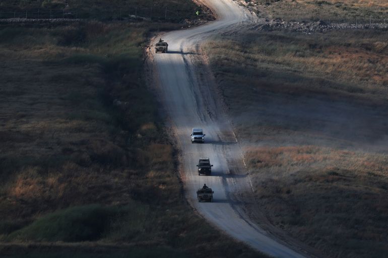 epa13054642 Israeli military vehicles maneuver on the Lebanese side of the Israel-Lebanon border, as seen from the Upper Galilee, in northern Israel, 21 June 2026. Israel and Hezbollah agreed to a new ceasefire on 19 June 2026, after a flare-up nearly derailed peace talks in the region. EPA/ATEF SAFADI