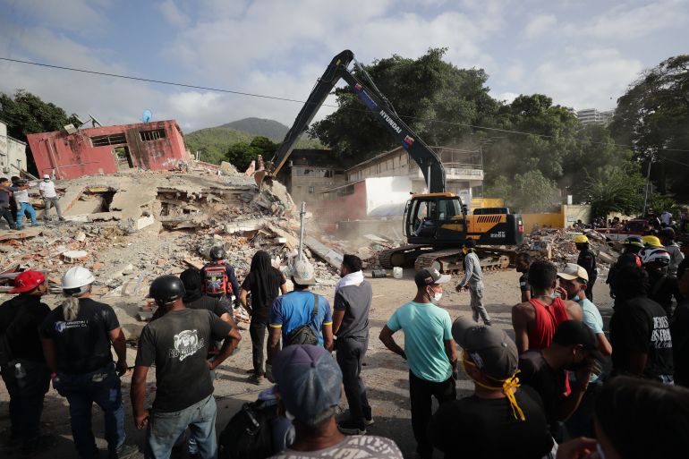 epa13068193 A backhoe operates in an area affected by an earthquake in La Guaira, Venezuela, 26 June 2026. Venezuelan Interior Minister Diosdado Cabello announced that access to La Guaira state, the area hardest hit by the earthquakes, will be restricted starting at 20:00 local time (00:00 GMT on 27 June). EPA/Ronald Pena R