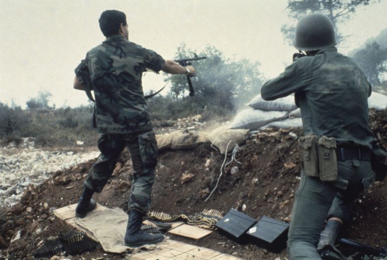 Christian militiamen fire their 155mm howitzer towards Druze positions as fighting continues in Lebanon's Chouf Mountains in September 1983. (AP Photo/Bill Foley)