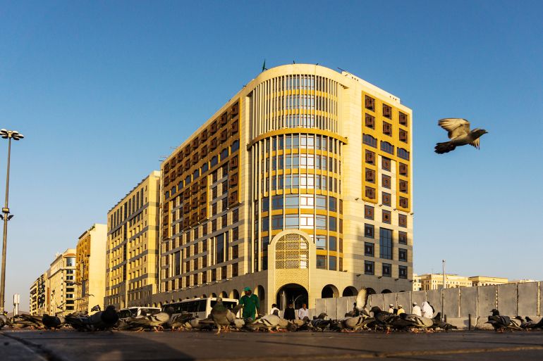 Street view with modern buildings, pedestrian bridge, and traffi المصدر: أدوبي ستوك