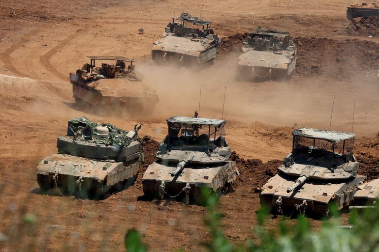 This picture taken from a position in the Upper Galilee in northern Israel shows Israeli army tanks positioned along the Israel-Lebanon border, on July 1, 2026.