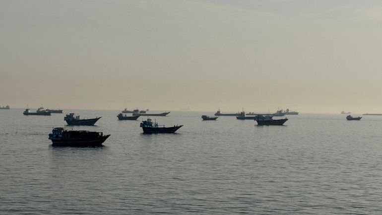 (FILES) Vessels are seen anchored in the Strait of Hormuz, off the port city of Khasab on Oman’s northern Musandam Peninsula on May 17, 2026.