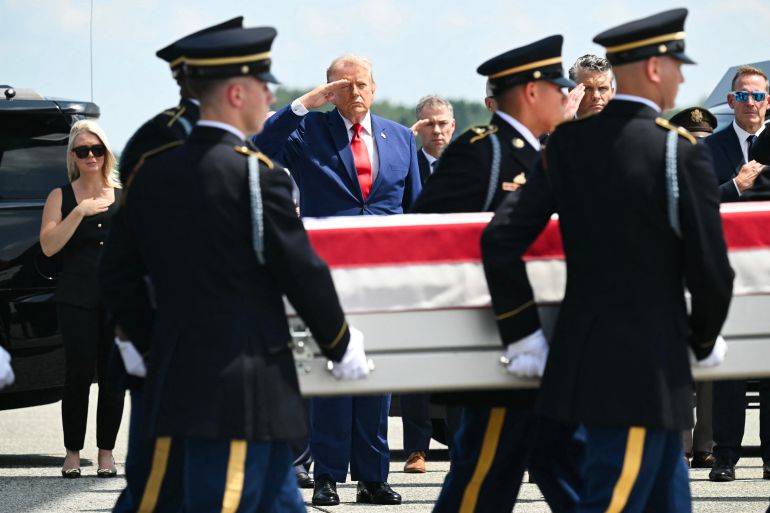 US President Donald Trump salutes as a US Army carry team carries the flag-draped transfer case containing the remains of 1st Lt. Tyler James Feehan, 25, of Ewa Beach, Hawaii, during a dignified transfer solemn event for US service members killed during operations in the Middle East, at Dover Air Force Base in Dover, Delaware, on July 22, 2026.