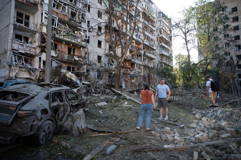 People look at a residential building damaged during the Russian missile attack in Kyiv, Ukraine, Thursday, July 2, 2026. (AP Photo/Danylo Antoniuk)