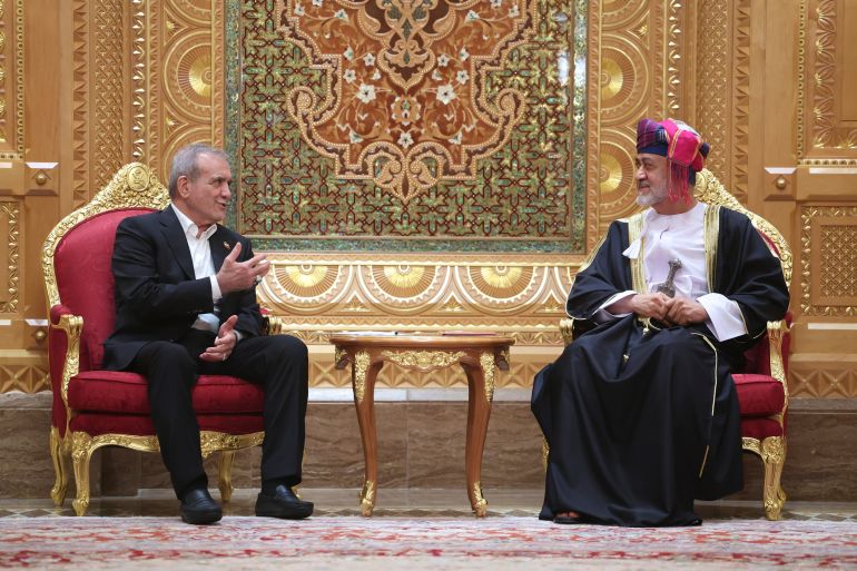 In this photo released by the Iranian Presidency Office, President Masoud Pezeshkian, left, speaks with Oman's Sultan Haitham bin Tariq Al Said during their meeting in Muscat, Oman, Tuesday, May 27, 2025. (Iranian Presidency Office via AP)