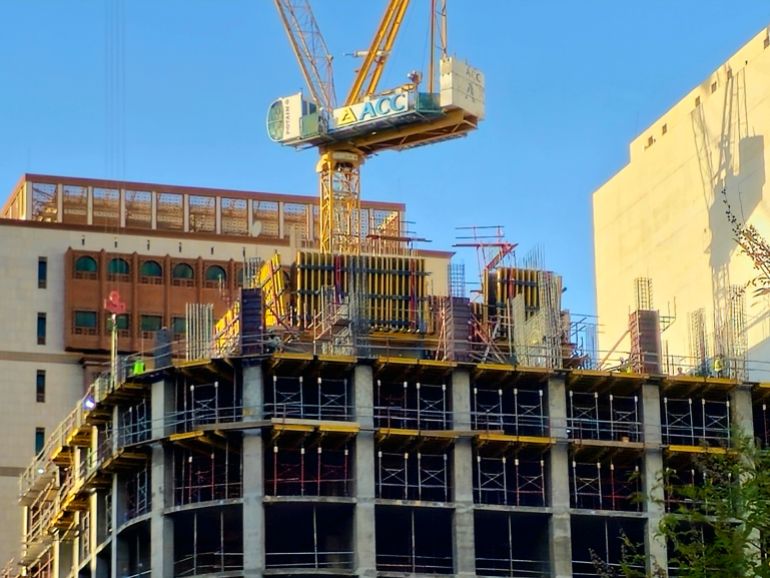 Medina, Saudi Arabia, June 26 2024: a new high building in Madinah city that is under construction, with a crane tower of ACC Arabian Construction Company, ACC is leading construction firm in the MENA أدوبي ستوك