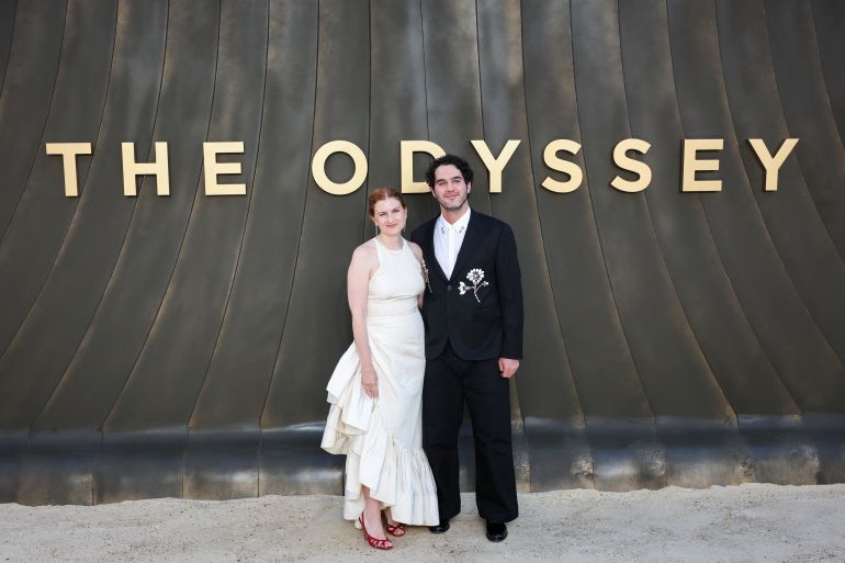 Cast member Benny Safdie and a guest attend the "The Odyssey" world premiere in London, Britain, July 6, 2026. REUTERS/Isabel Infantes