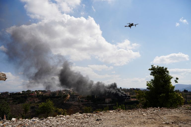 Smoke rises in Zawtar al-Sharqiyah as a drone flies in the nearby Zawtar al-Gharbiyeh, southern Lebanon, September 22, 2026. REUTERS/Stringer